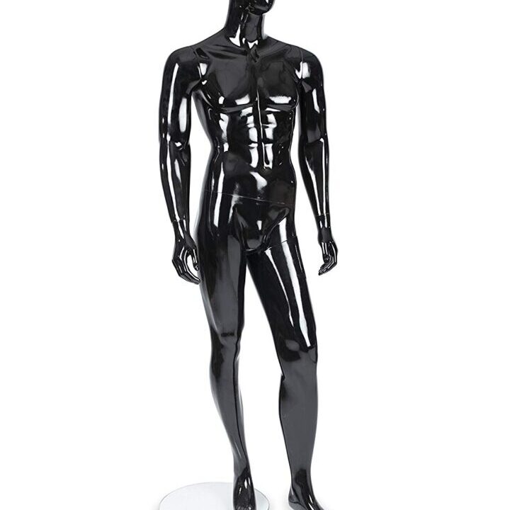 A black mannequin standing in front of a white background.